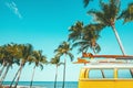 vintage car parked at the tropical beach seaside with a surfboard on the roof Royalty Free Stock Photo