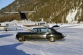 A vintage car and private jets in the airport of Engadine St Moritz