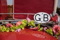 A vintage car roof rack with flowers an a GB badge