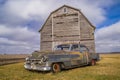 Vintage car and rustic barn. Royalty Free Stock Photo