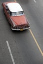 Vintage car driving down a road in Havana Cuba