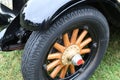 A vintage car wheel with wooden spokes Royalty Free Stock Photo