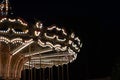 Vintage carousel lights in the park, retro merry-go-round on a summer evening Royalty Free Stock Photo