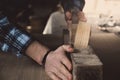 Vintage carpenter working on wood using wood retro vintage old ancient planer. Workshop background