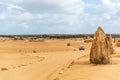 Vintage cars driving on dirt road in the Pinnacles Desert, Australia