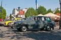 Vintage Saab 95 parked on a market.