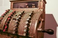 Vintage cash register with round buttons with numbers in a sepia tone close up Royalty Free Stock Photo