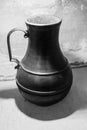 Antique metal jug, black and white photo.