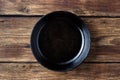 Vintage cast iron pan on wooden rustic background Royalty Free Stock Photo