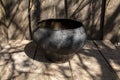 Vintage cast-iron pot of black color on wooden boards Royalty Free Stock Photo
