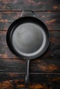 Vintage cast iron skillet with copy space for text or food with copy space for text or food, top view flat lay , on old dark Royalty Free Stock Photo