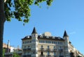 Vintage castle like facades with modernist windows and elegant balconies seen through greenery on the streets of Barcelona, Spain