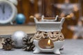 Vintage ceramic aroma lamp for aromatherapy in winter composition. Candle flame and essential oil vapor. Close-up, selective focus