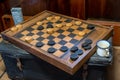 Vintage checkers board and pieces in the mess room of an sailboat