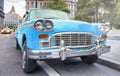 Vintage chequered blue taxi cab in New York City. Manhattan street traffic Royalty Free Stock Photo