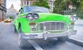 Vintage chequered green taxi cab in New York City. Manhattan street traffic Royalty Free Stock Photo