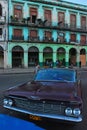 Classic vintage Chevrolet yank tank Cuban car of Cuba in front of old building in Havana Royalty Free Stock Photo