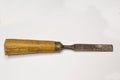 Vintage Chisel tool made of metal with wooden handle on gray background
