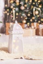 Vintage Christmas background. Christmas lantern with  christmas decoration against fir tree blur lights. Festive moon, magic light Royalty Free Stock Photo