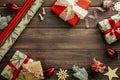 Vintage Christmas background with gift boxes, Xmas decorations, wrapping paper on wooden table. Flat lay, top view, copy space. Royalty Free Stock Photo