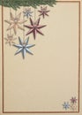 Vintage christmas card with stars hanging hanging from a spruce branch