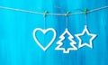 Vintage Christmas decorations hanging on string on blue background Royalty Free Stock Photo