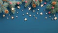 Vintage Christmas frame border. Flat lay fir tree branches, red berries, wooden stars on blue background. Top view, copy space. Royalty Free Stock Photo