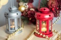 Vintage Christmas Lanterns Red and gray with burning Candles. Cozy christmas decorations with golden beads and balls. Christmas Royalty Free Stock Photo