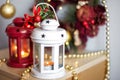 Vintage Christmas Lanterns Red and White with burning Candles. Cozy christmas decorations with golden beads and balls. Christmas Royalty Free Stock Photo