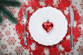 Vintage Christmas plate on holiday background with red heart