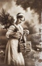 Vintage Christmas postcard young woman with gifts Royalty Free Stock Photo