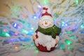 Vintage Christmas toy smiling snowman on a beautiful colored background. Royalty Free Stock Photo