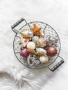 Vintage Christmas toys in a metal basket on a fluffy carpet, top view Royalty Free Stock Photo