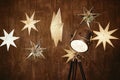 Vintage chrome tripod spotlight and stars ligths on brown wood wall, copy space. Floor lamp, lampshade. Christmas background Royalty Free Stock Photo