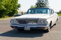 A vintage Chrysler New Yorker stands in the parking lot in front of the Burgenland classic.