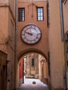 Vintage circle clock on antique building exterior. Old town street details photo. Retro painted textured weathered wall Royalty Free Stock Photo