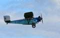 Vintage 1931 Civilian Coupe 02 G-ABNT aircraft in flight with blue sky and clouds.