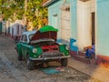 Vintage classic American car get repaired on the street Royalty Free Stock Photo