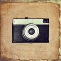 Vintage classic camera on old grunge paper Royalty Free Stock Photo