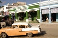Vintage classic car in front of Cuban shop