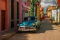 Vintage classic car parked on a street Santiago de Cuba.