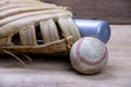 Vintage classic leather baseball glove and baseball bat isolated on wooden table. Royalty Free Stock Photo