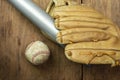 Vintage classic leather baseball glove and baseball bat isolated on wooden background. Royalty Free Stock Photo