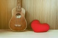 Vintage classic ukulele with red heart and blank area or space