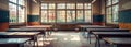 Vintage classroom interior with wooden desks and sunlight. Education school background Royalty Free Stock Photo
