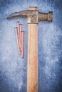 Vintage claw hammer copper construction nails on metallic backgr Royalty Free Stock Photo