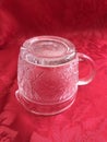 Vintage Pressed Glass Clear Crystal Cream Pitcher on red Background Royalty Free Stock Photo