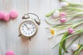 Vintage clock alarm clock set for morning, pink sweet macarons. Royalty Free Stock Photo