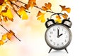 Vintage clock and autumn colors leaves Fall daylight savings time change concept Royalty Free Stock Photo