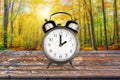 Vintage clock in a forest in autumn Fall daylight savings time change concept Royalty Free Stock Photo